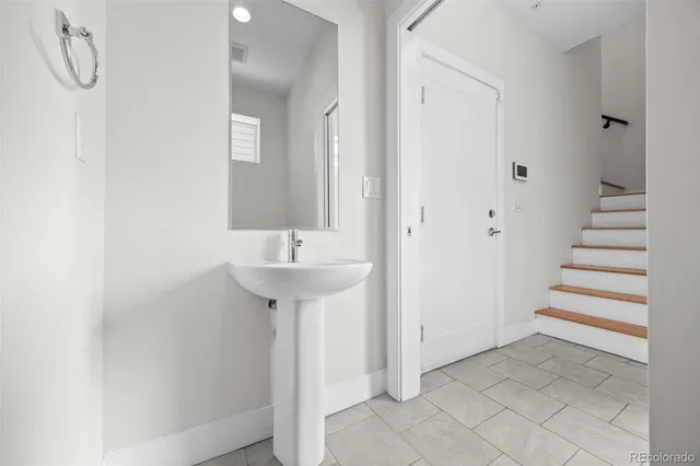 a bathroom with a sink and mirror