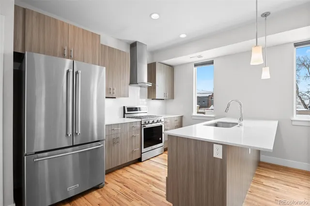 a kitchen with stainless steel appliances a refrigerator sink and cabinets