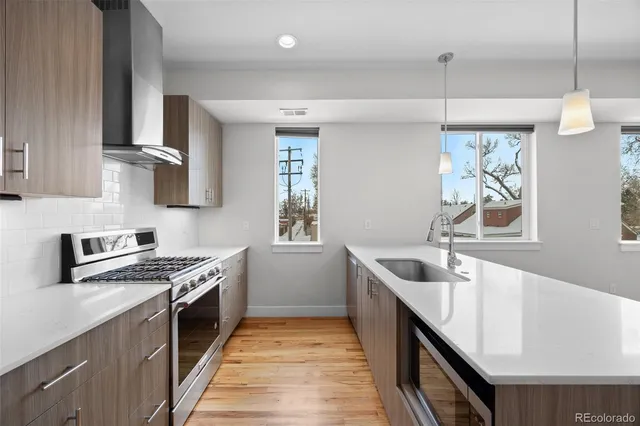 a kitchen with granite countertop a sink stove and cabinets