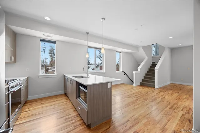 a kitchen with wooden floor and window