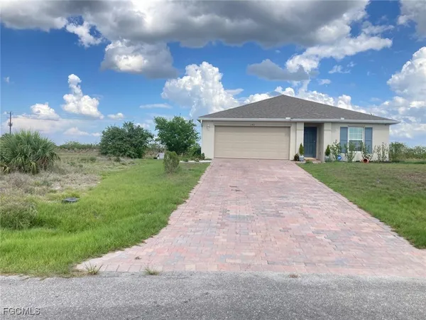 a view of a house with a yard and a garden