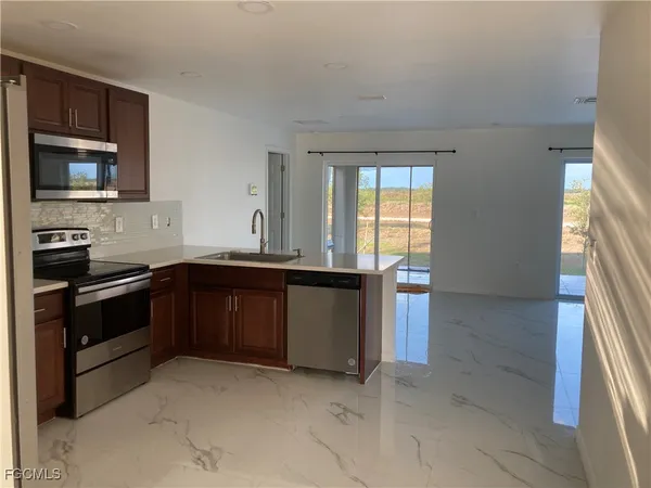 a kitchen with granite countertop a stove and a sink