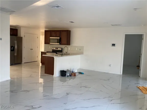 a kitchen with stainless steel appliances a stove and a refrigerator