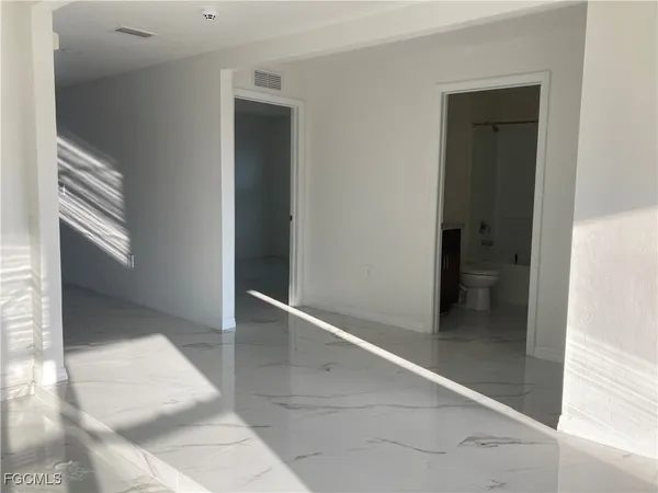 hallway with wooden floor and glass door