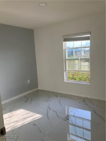 a view of a hallway with a glass door and a window