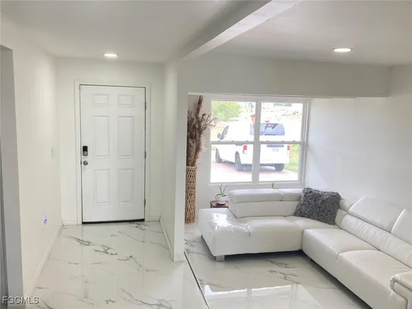 a living room with furniture and a large window