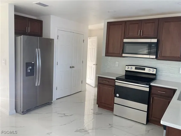 a kitchen with a refrigerator stove and microwave