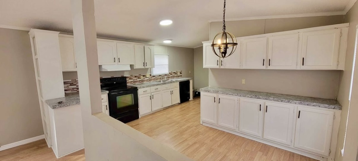 1941 Evans Road Clarksville, TN 37042 - Photo 2 of 6 a kitchen with stainless steel appliances granite countertop a stove a sink and white cabinets