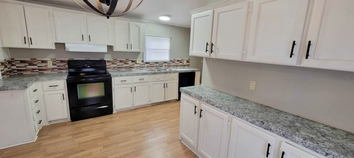 1941 Evans Road Clarksville, TN 37042 - Photo 3 of 6 a kitchen with granite countertop white cabinets and white appliances