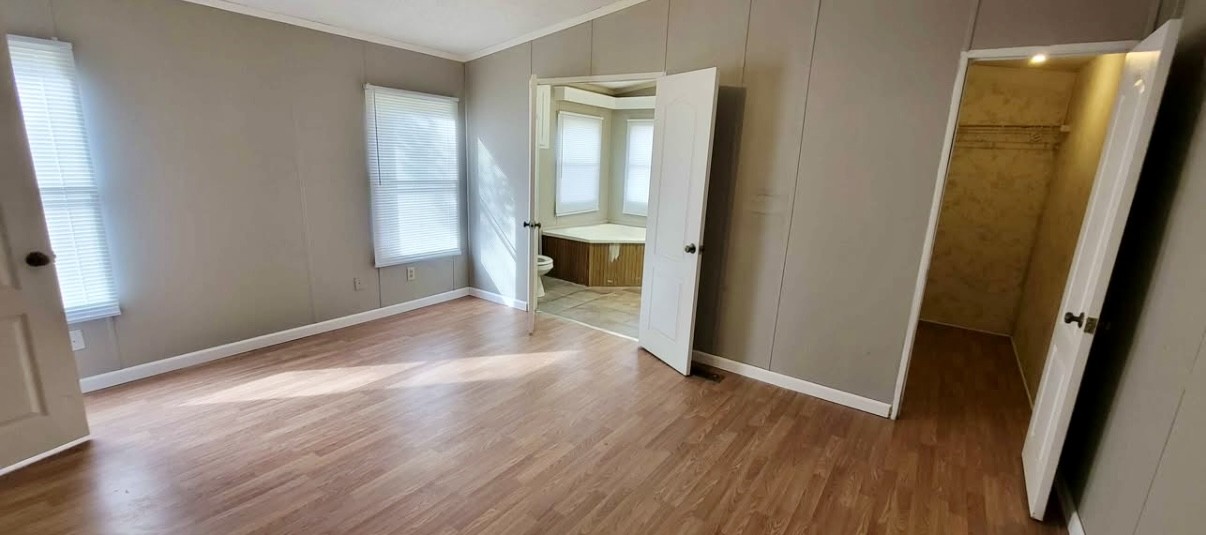 1941 Evans Road Clarksville, TN 37042 - Photo 5 of 6 an empty room with wooden floor and a bathroom