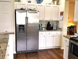 a kitchen with stainless steel appliances a refrigerator sink and cabinets