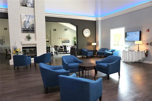 a living room with fireplace furniture and a wooden floor