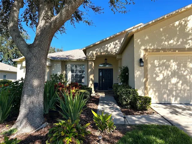 a view of a porch with chairs and flower plants