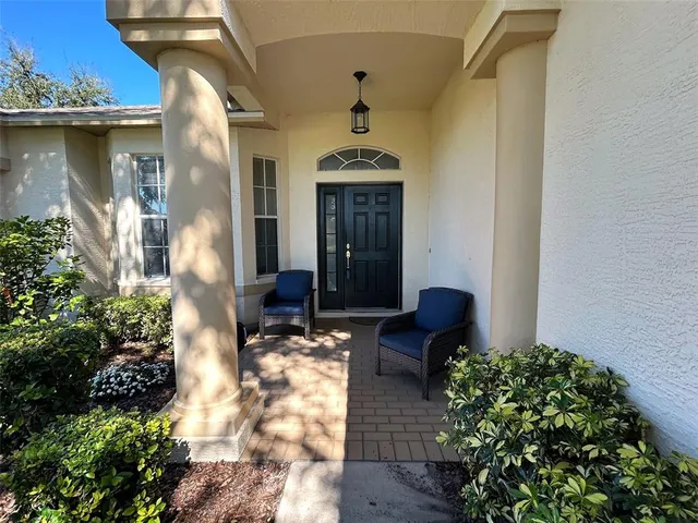 a front view of a house with fountain
