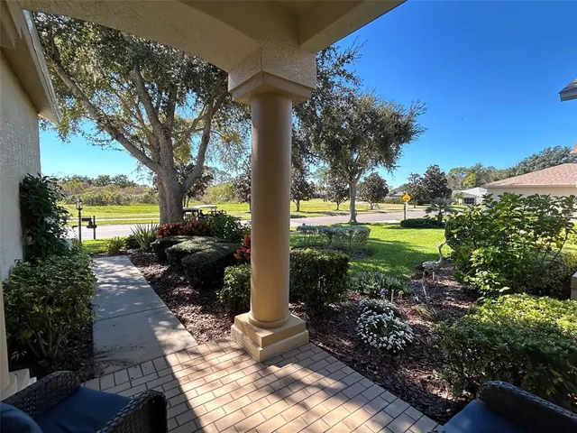 a view of a backyard with sitting area