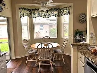 a view of a dining room with furniture and window