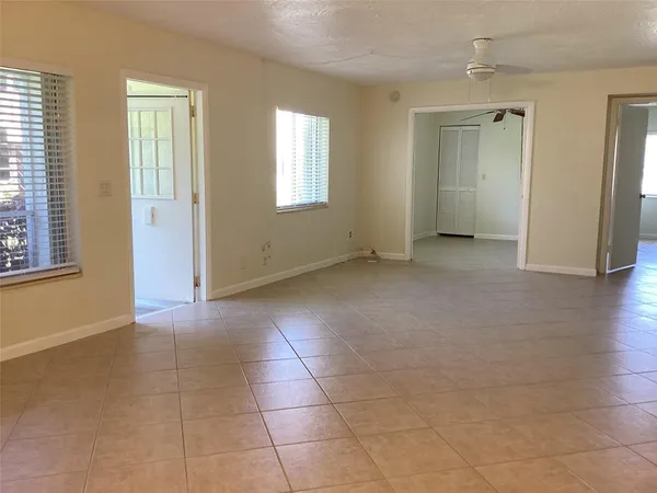 an empty room with windows and closet