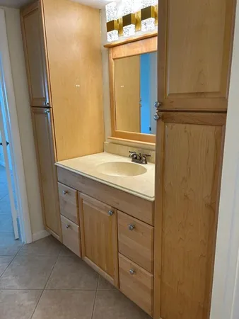 a bathroom with a sink a mirror and a vanity