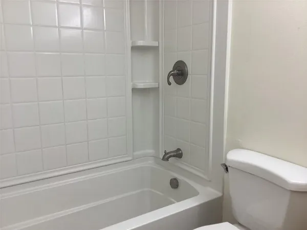 a bathroom with a bathtub and toilet