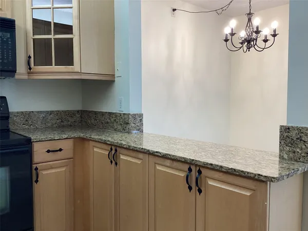 a view of a kitchen with a sink and cabinets