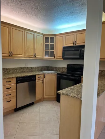 a kitchen with a stove and a sink