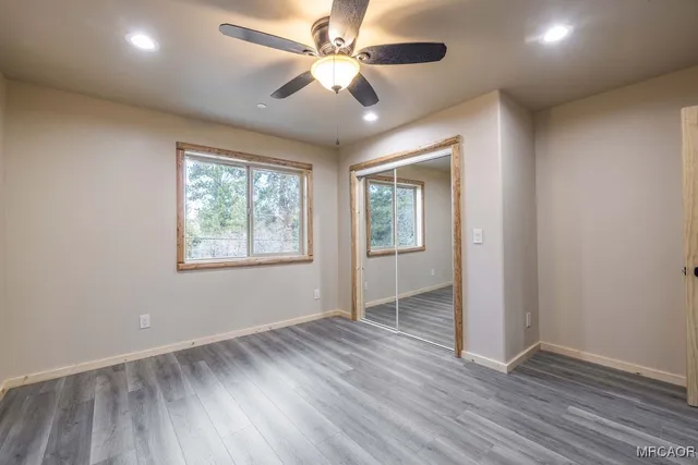 a bathroom with a granite countertop sink and a large mirror