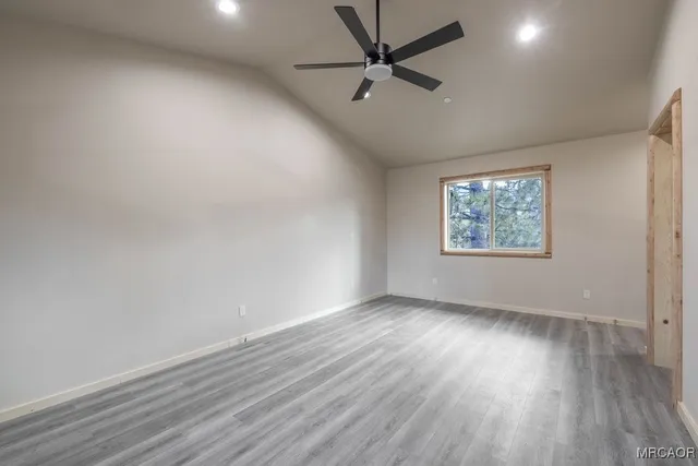 a bathroom with a granite countertop sink a toilet a mirror and shower