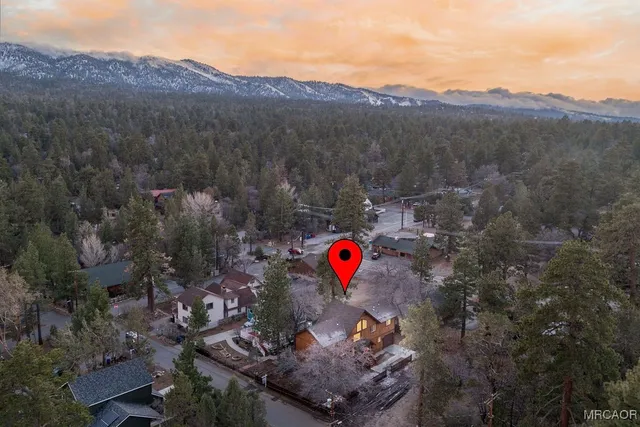 a view of a kitchen with kitchen island a window a sink and a counter top space