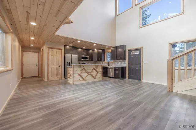 a view of an entryway with wooden floor