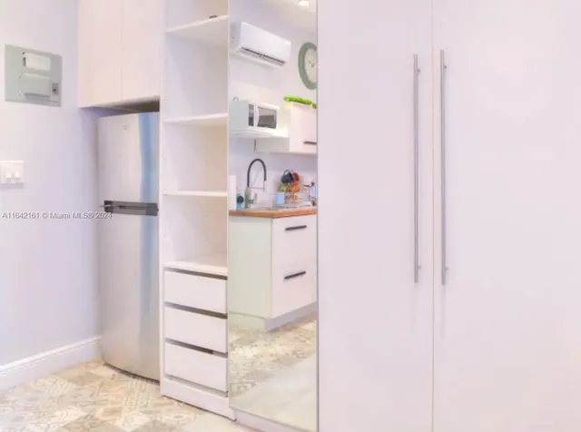 a living room with furniture a chandelier and a table