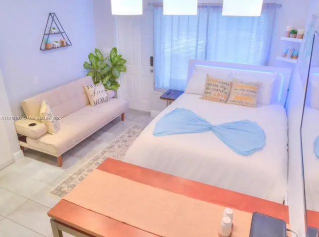 a view of a hallway with wooden floor and a rug