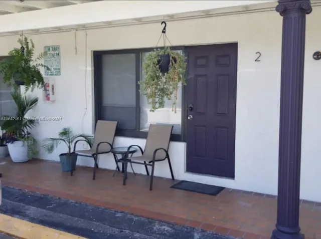 a living room with flat screen tv and a window