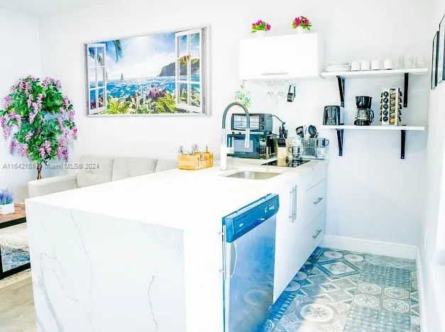 a living room with stainless steel appliances kitchen island granite countertop furniture and a rug