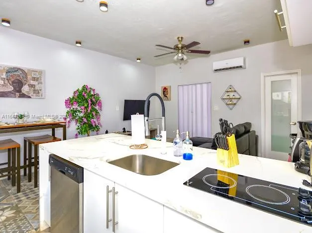 a bedroom with a bed a flat tv screen and a potted plant