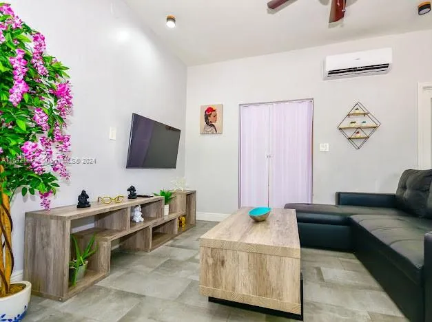 a living room with furniture and a potted plant