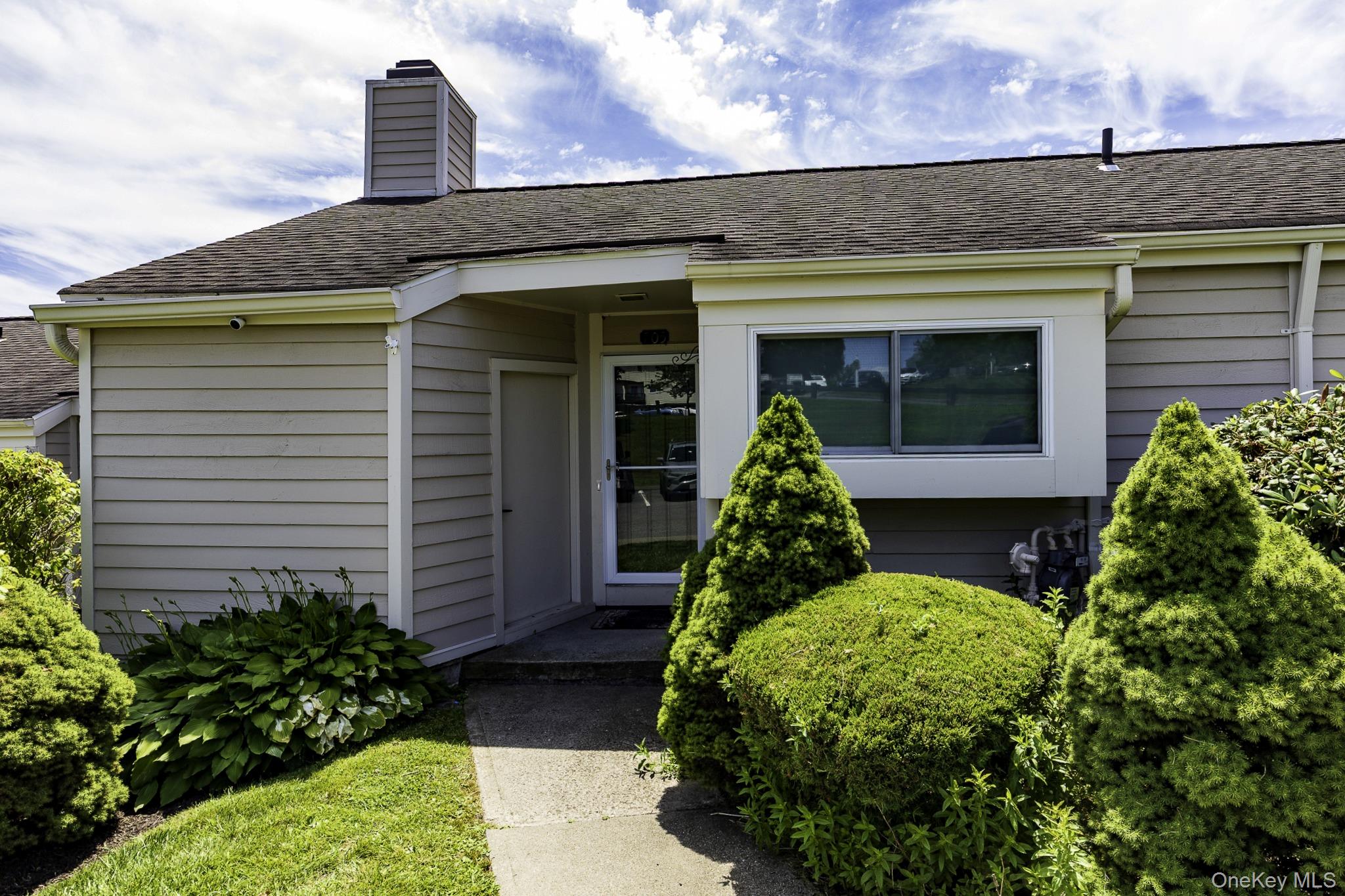 a front view of a house with garden