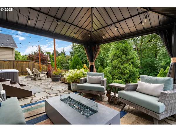 a view of a patio with couches table and chairs and potted plants