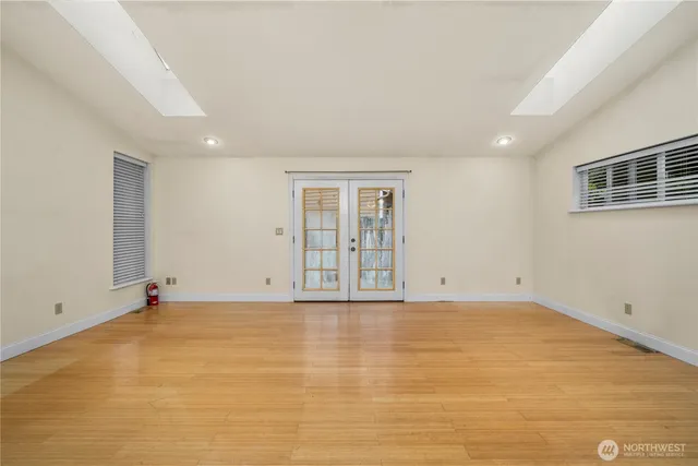 a view of an empty room with wooden floor