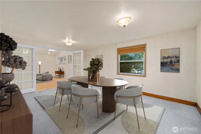 a view of a dining room with furniture and a window