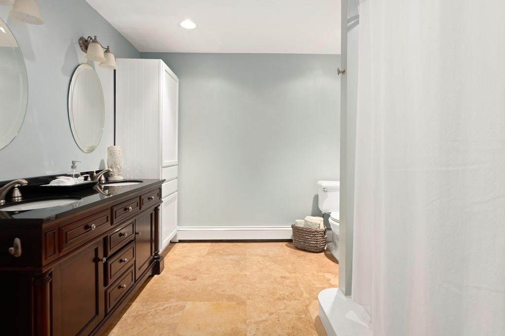 12 South Road Exeter, NH 03833 - Photo 27 of 42 a bathroom with a sink and a mirror
