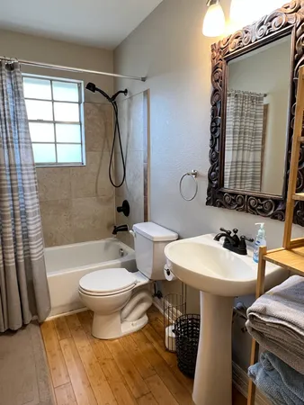 a bathroom with a sink toilet and shower