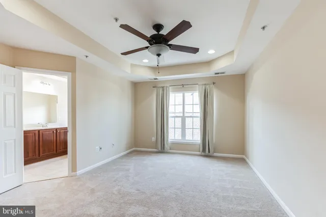 a view of an empty room with a ceiling fan