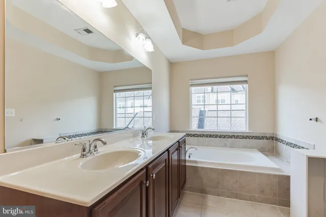 a bathroom with a bathtub a sink and a window
