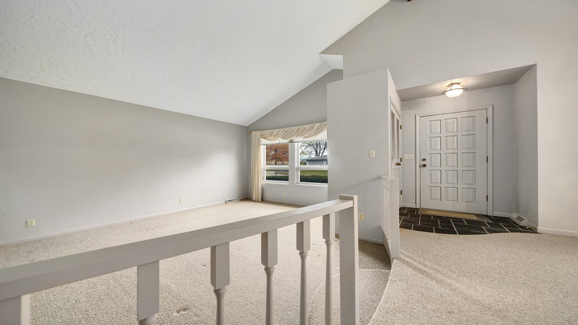 1247 Roxbury Road Rockford, IL 61107 - Photo 5 of 37 a view of a hallway to a livingroom with wooden floor and entryway