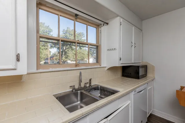 a kitchen with stainless steel appliances a sink a stove and a microwave