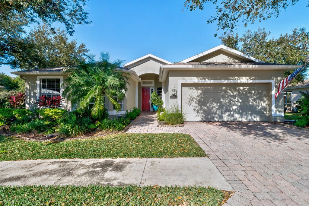 3812 Kitty Hawk Lane Southwest Vero Beach, FL 32968 - Photo 1 of 36 a front view of a house with garden
