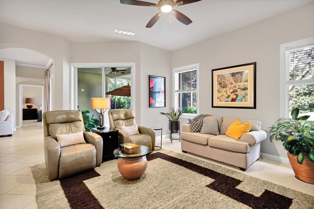3812 Kitty Hawk Lane Southwest Vero Beach, FL 32968 - Photo 11 of 36 a living room with furniture a rug and a chandelier