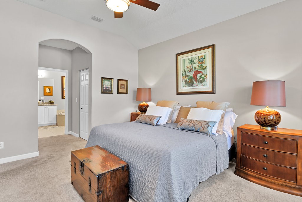 3812 Kitty Hawk Lane Southwest Vero Beach, FL 32968 - Photo 14 of 36 a bedroom with a bed and cabinet