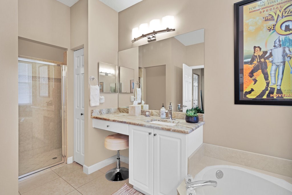 3812 Kitty Hawk Lane Southwest Vero Beach, FL 32968 - Photo 15 of 36 a bathroom with a granite countertop sink mirror and a bathtub
