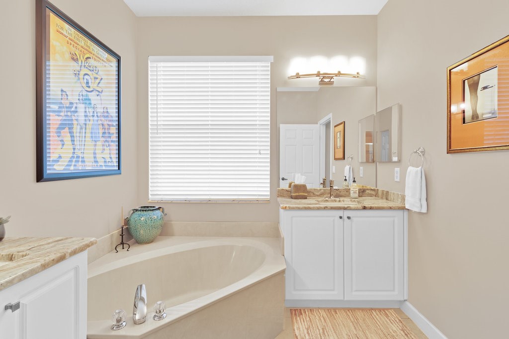 3812 Kitty Hawk Lane Southwest Vero Beach, FL 32968 - Photo 16 of 36 a bathroom with a bathtub and a sink